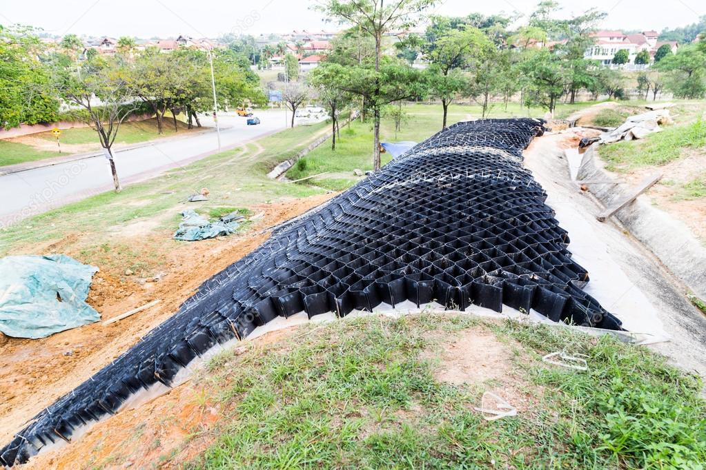 Slope erosion control with grids and earth on steep slope