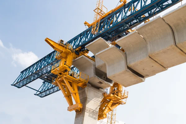 Construction of a mass transit train line in progress with heavy infrastructure.