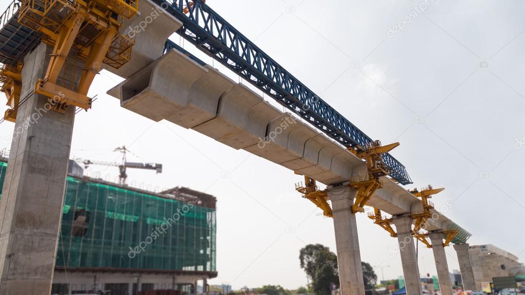 Construction of a mass transit train line in progress with heavy infrastructure.