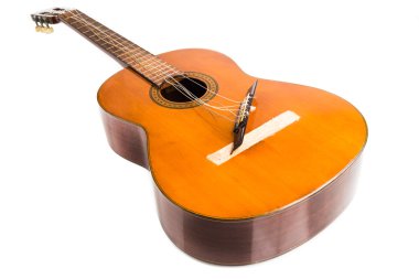 Broken classical guitar with detached bridge isolated in white background