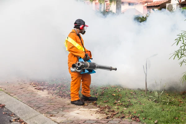 Trabajador empañando área residencial con insecticidas para matar aedes — Foto de Stock