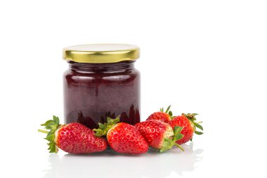 Organic strawberry jam in transparent glass jar with fresh straw