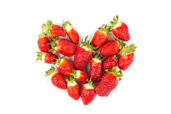 Heaps of strawberries form heart shape on white background — Stock Fotó