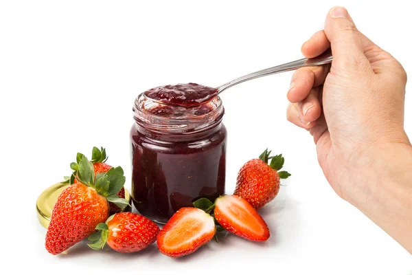 Spoon scooping organic strawberry jam in transparent glass jar — Stock Photo, Image