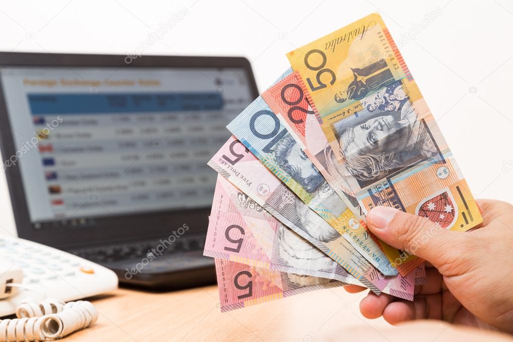 sikkerhedsstillelse Distill Diskutere Hand holding Australian dollar in office in front of currency exchange chart on computer screen. Stock Photo by ©Thamkc 95775166 sikkerhedsstillelse Distill Diskutere Hand holding Australian dollar in office in front of currency exchange chart on computer screen. Stock Photo by ©Thamkc 95775166
