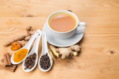 Healthy turmeric tea with black pepper, cinnamon, cloves and ginger