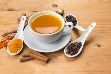 Healthy turmeric tea with black pepper, cinnamon, cloves and ginger