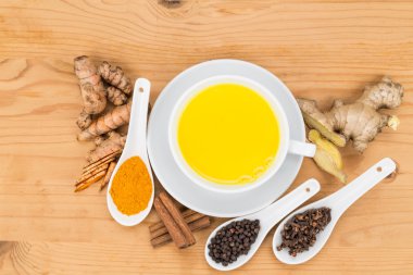 Healthy turmeric milk tea with ginger, cinnamon, cloves, black pepper