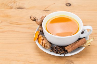 Healthy turmeric tea with black pepper, cinnamon, cloves and ginger