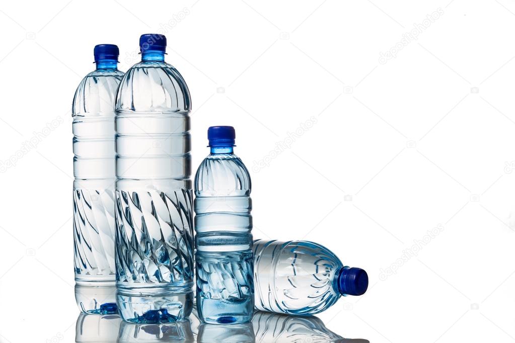 Four refreshing mineral water in plastic bottle in white background