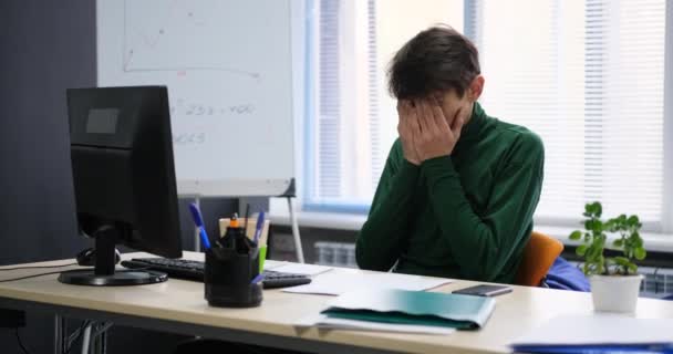 Joven hombre de negocios en la oficina cansado y triste trabajando en el ordenador — Vídeo de stock