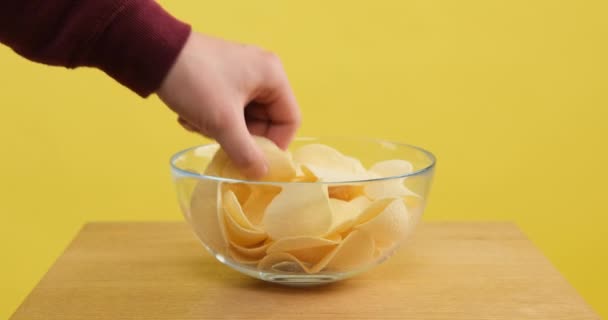 Female and male hands takes the chips from the bowl — Stock Video