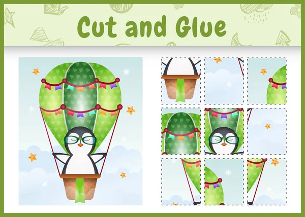 Çocukların masa oyunu, sıcak hava balonunda şirin bir penguenle kes ve yapıştır.