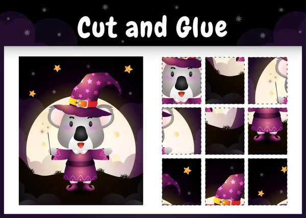 Cadılar Bayramı kostümü giyen sevimli bir koalayla çocuk masa oyunu kes ve yapıştır