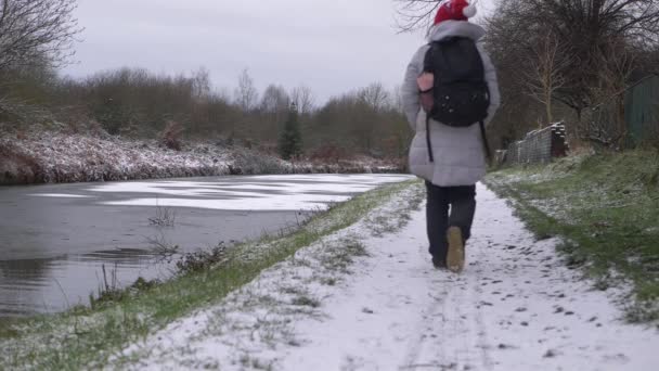 Kvinnliga vandrare på kanal väg efter snö faller — Stockvideo