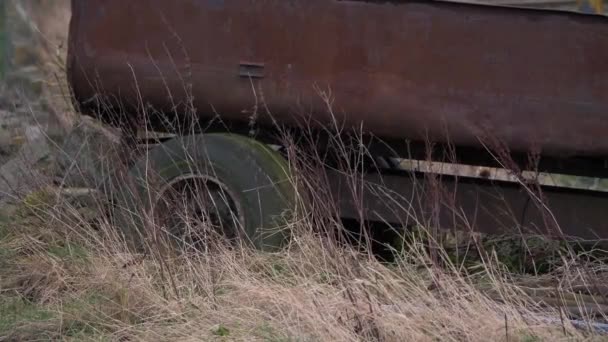 Rusty old farming trailer dumped in farmland — Stock Video