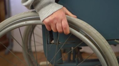 Tekerlekli sandalye kullanıcısı evdeki sandalyeyi döndürüyor