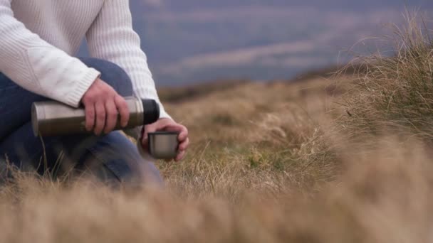 Hiker with thermos in rugged landscape — Stock Video
