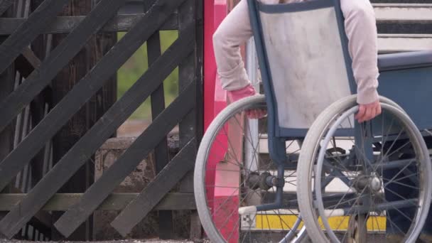 Wheelchair user approaches steps — Stock Video