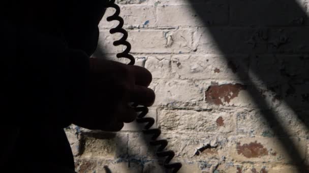 Mysterious phone call on vintage phone in a dirty basement — Stock Video