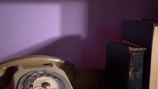 Vintage retro phone on book case — Stock Video