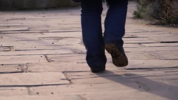 Piernas caminando por la calle vacía pavimentada — Vídeos de Stock