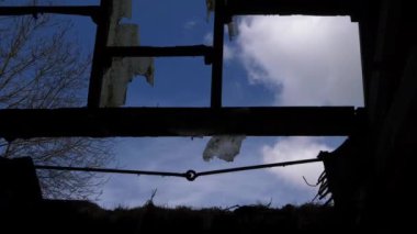 Terk edilmiş bina penceresi görünümünde bulutların zaman akışı