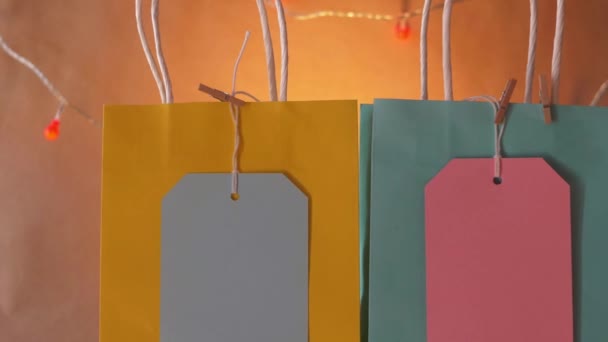 Gift bags and labels on warm background — Stock Video