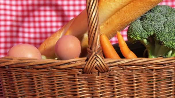 Basket of fresh food on red gingham background — Stock Video