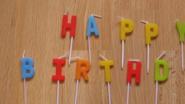 Happy birthday in colorful letters on wooden background — Stock Video