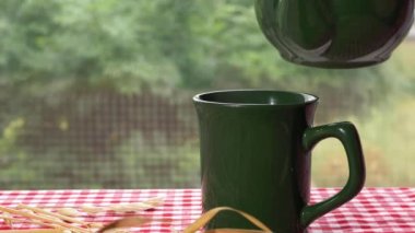 Mutfak penceresinden içeri sıcak çay dökülüyor.