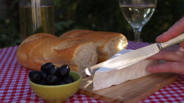 Brie és olajbogyó a piknik asztalon — Stock videók