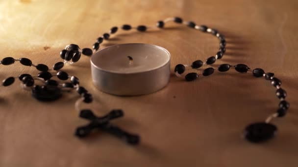 Lighting a candle with rosary beads — Stock Video