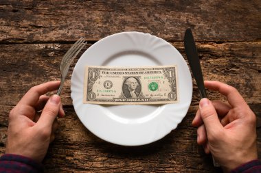 bıçak ve çatal bir dolar olan kalenin yanındaki tutan adam