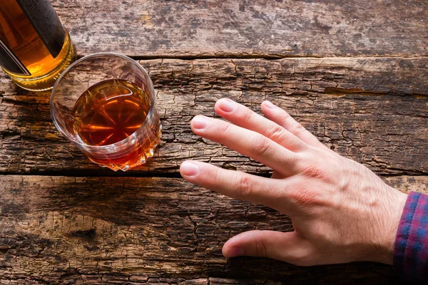 Man reaches to alcohol — Stock Photo, Image