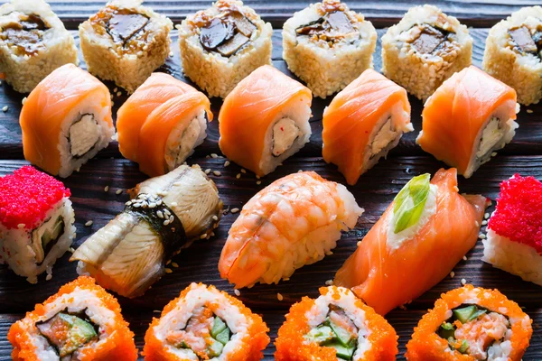 Set of sushi rolls and nigiri on a black background closeup — Stock Photo, Image