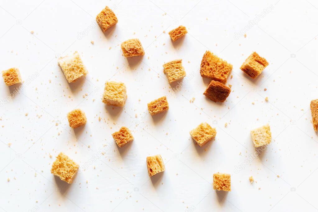 crumbs of roasted white bread on a white background closeup
