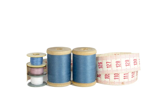 Spools of thread with a ruler isolated over white — Stock Photo, Image