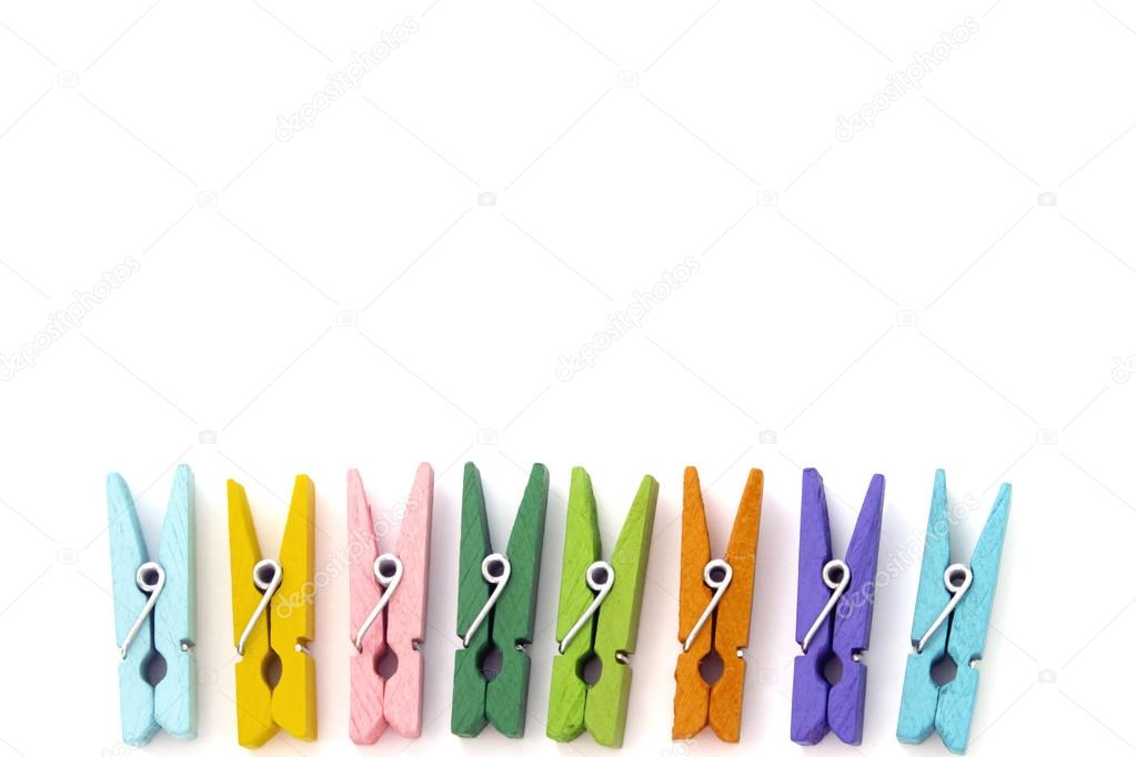 Background of multi colored linen clothespins isolated on white
