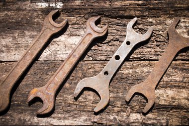 Iron rusty tools wrench on an old wooden table