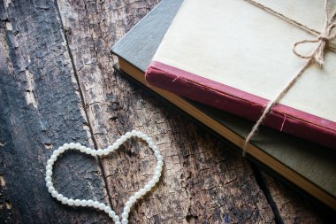 Corded book with heart-shaped beads