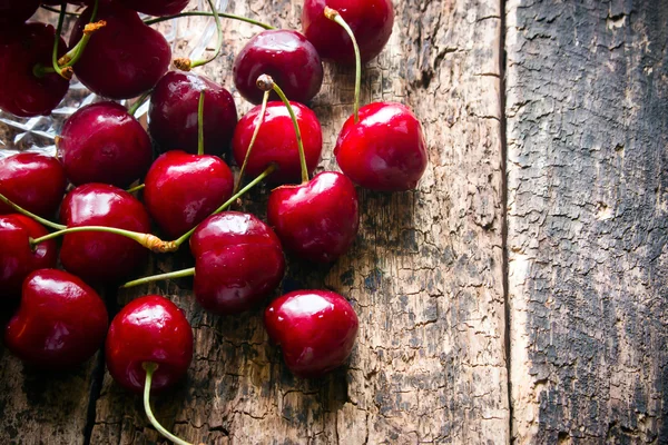 Sprinkled rustic cherry on a wooden table close-up — Stok fotoğraf