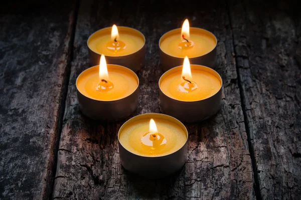 Scented candles burning on a wooden background — Stock Photo, Image