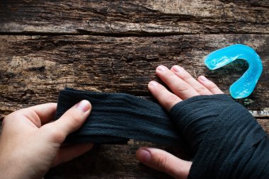 Man bandaging his hands before a fight near Kapa clipart