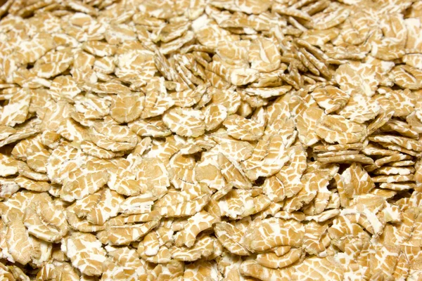 Wheat flakes as background — Stock Photo, Image