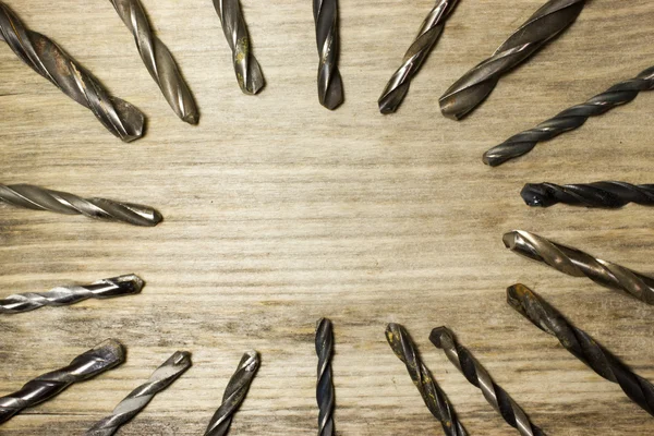 Drill bits on wooden background — Stock Photo, Image