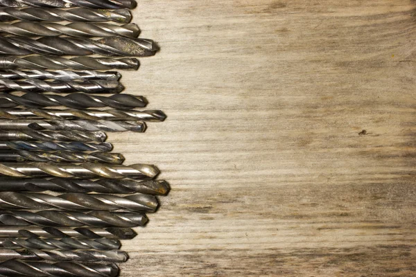 Drill bits on wooden background — Stock Photo, Image