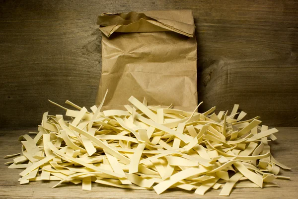 Wide Italian noodles on wooden background — Stock Photo, Image