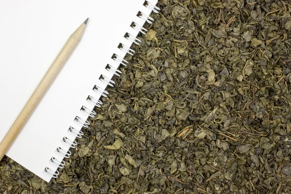 Dry green tea, a blank sheet of paper — Stock Photo, Image