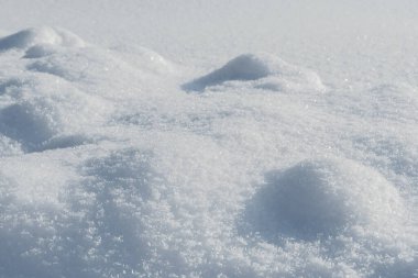 Güneşli kış gününde yumuşak kar yağışı olur. Derin ve yüksek kar sürükleniyor. Güneş ışığıyla aydınlanıyor ve gölgede kalıyor.